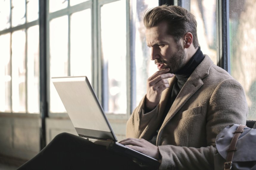 confused man staring at his laptop screen