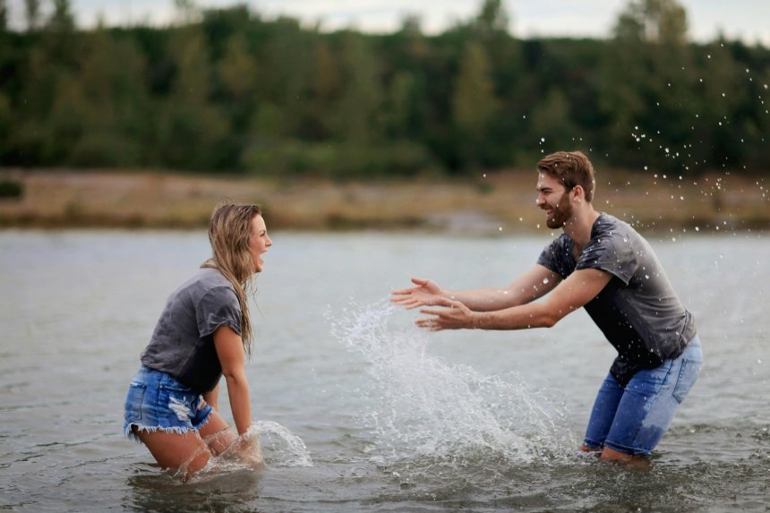 adventure loving couple having fun in the lake