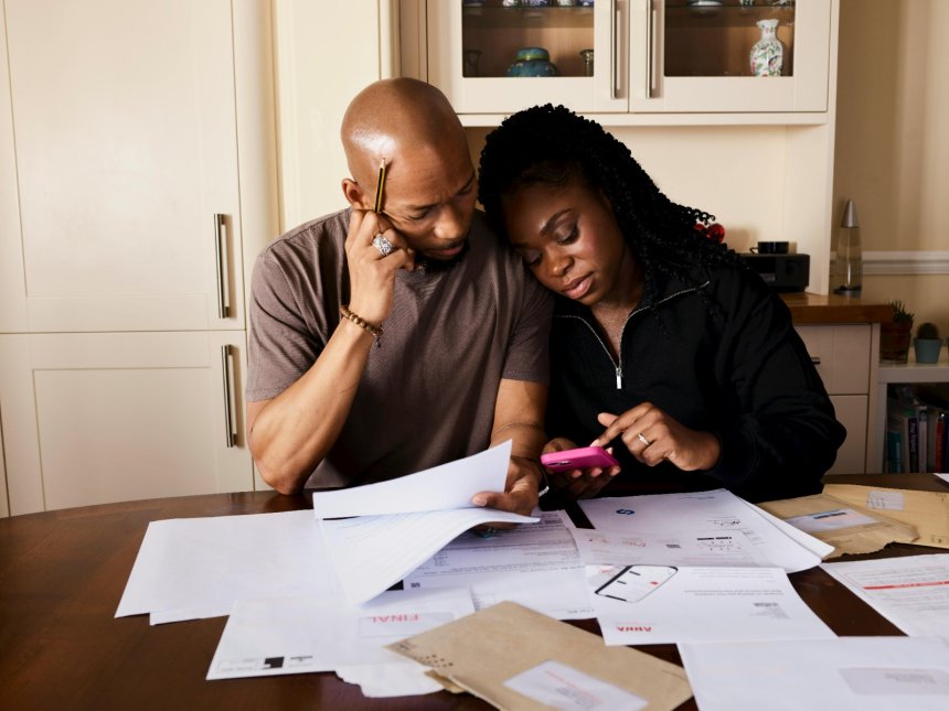 supportive husband calculating bills with wife