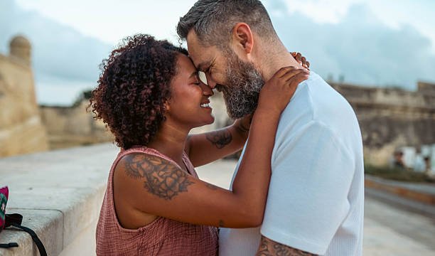 couple trying to maintain eye contact but getting nervous
