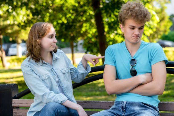 woman teasing displeased man